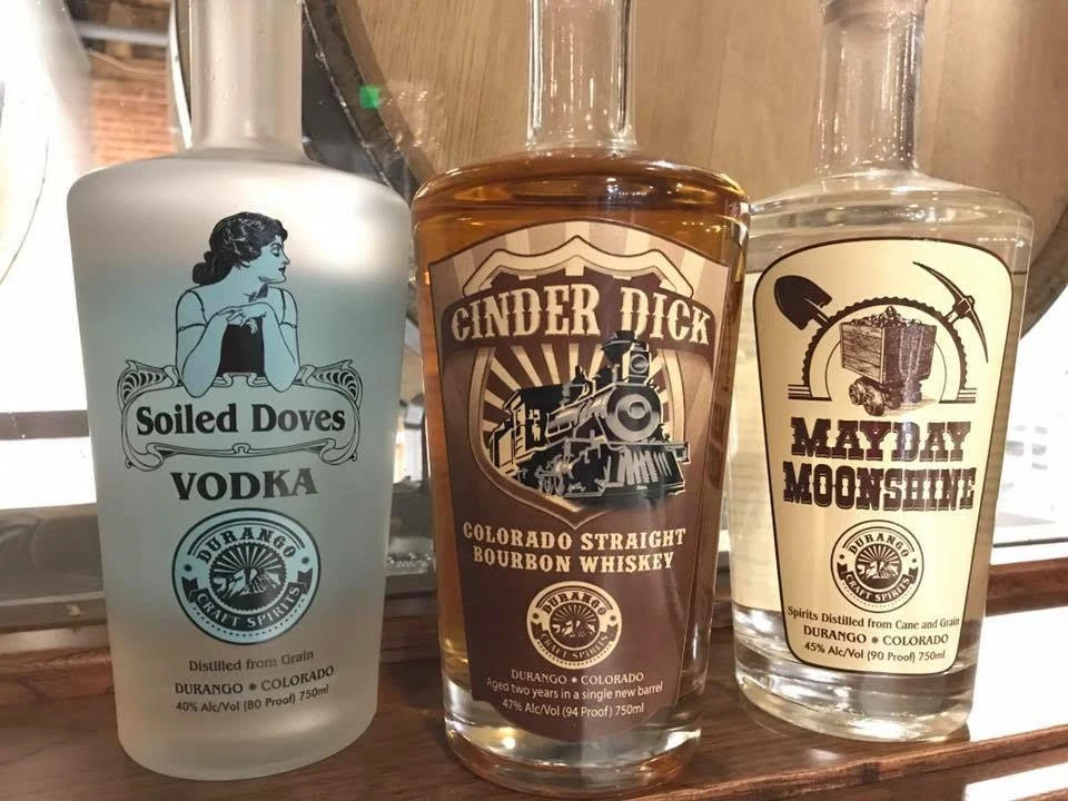 Soiled Doves Vodka, Cinder Dick Straight Bourbon and Mayday Moonshine bottles on the tasting-room bar